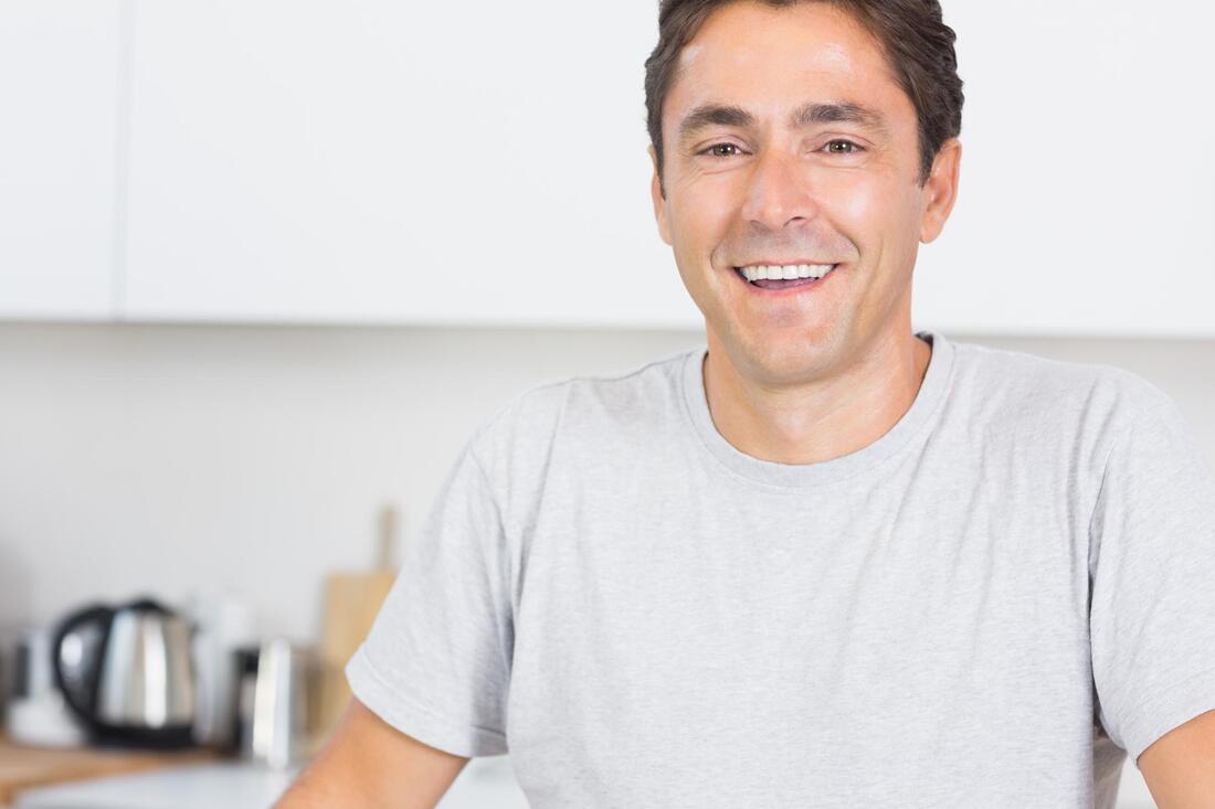 man smiling in a white shirt